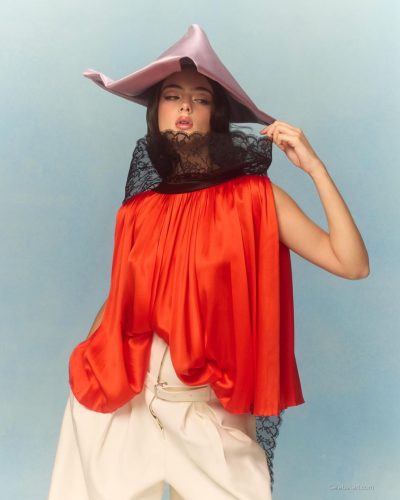 Deva Cassel in high-neck top with floral patterns.