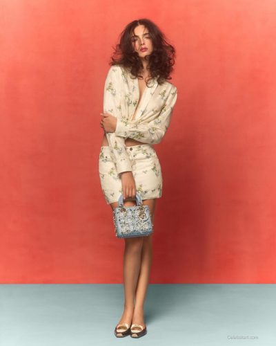 Deva Cassel in stylish high-neck floral top with flowy design.