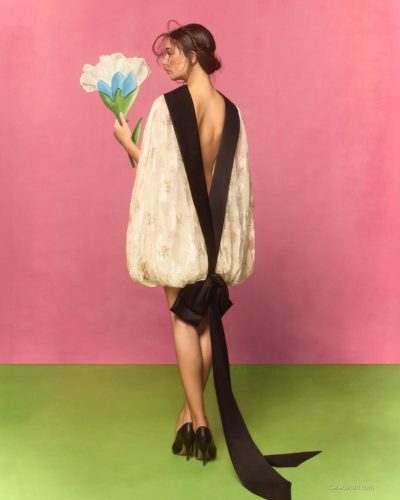 Deva Cassel in elegant satin gown with floral accents.