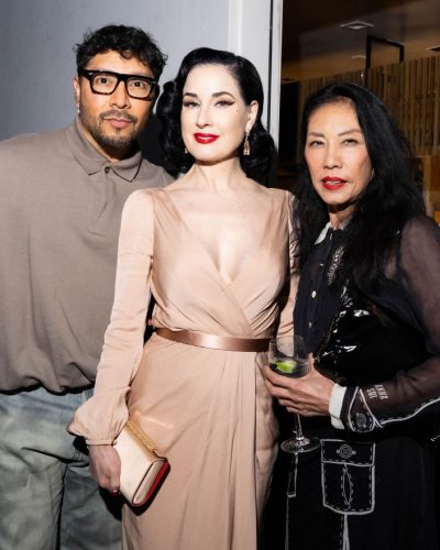 Dita Von Teese wearing a nude gown paired with bold lips.