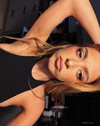 Dixie D'Amelio wearing classic black jumpsuit with relaxed fit