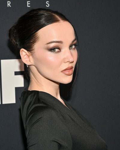 Dove Cameron in a sophisticated black gown with smoky eye makeup.