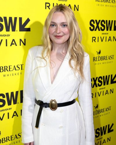 Elle Fanning in a striking red dress with a fitted silhouette