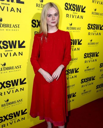 Elle Fanning in a bold red dress with flowing fabric