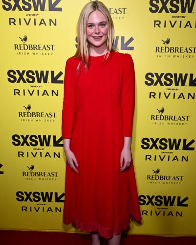 Elle Fanning in radiant red dress with dramatic flair