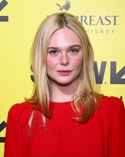 Elle Fanning in red fitted gown with sparkles and elegant sleeves