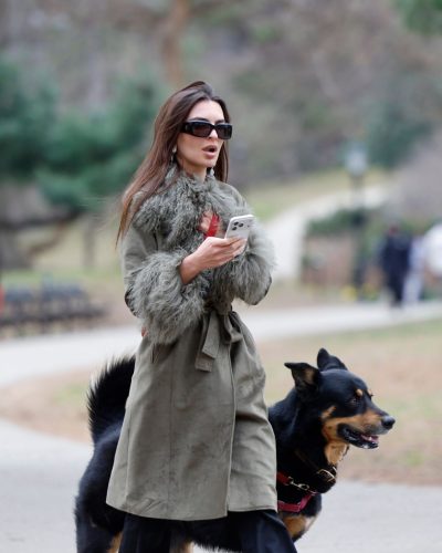Emily Ratajkowski green fur coat and comfortable black trousers combination.