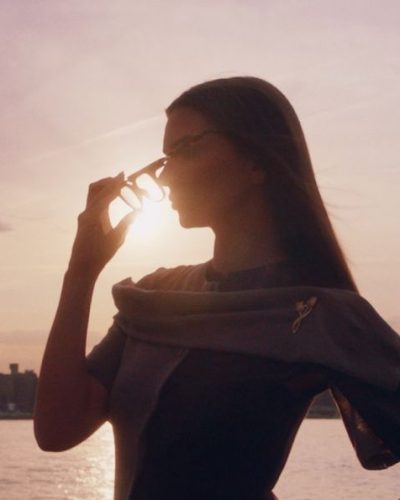 Emily Ratajkowski in floral gown complemented by sunset view