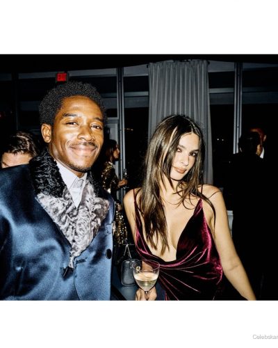 Emily Ratajkowski velvet dress with a fitted bodice and flowing skirt.