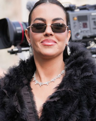 Georgina Rodriguez with edgy black dress and contemporary sunglasses.