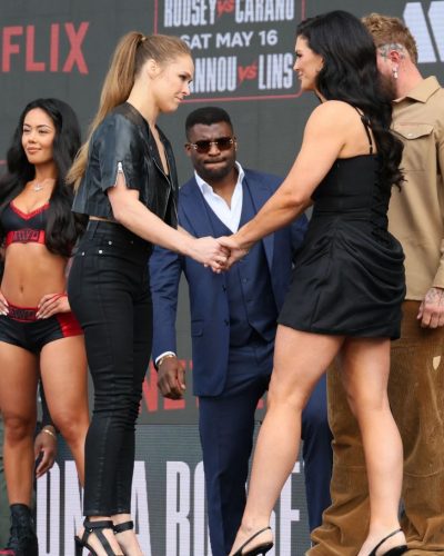 Gina Carano black leather jacket over black crop top