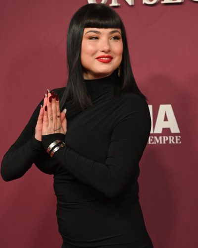 Giorgia Soleri contemporary black dress with a blunt fringe hairstyle