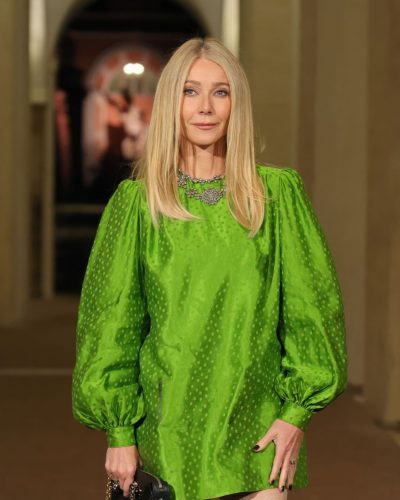 Gwyneth Paltrow wearing chic black handbag with green gown