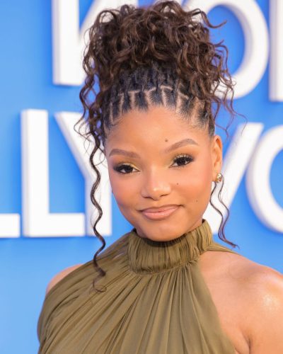Halle Bailey in vibrant blue backdrop with radiant lighting