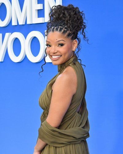 Halle Bailey in sophisticated olive green gown with flowing silhouette