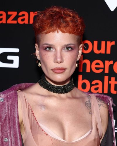 Halsey in pink coat layered over a nude dress.