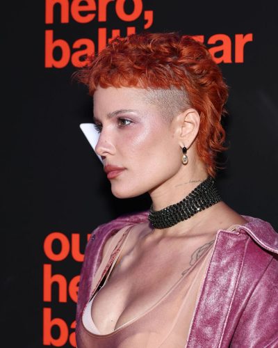 Halsey in vibrant orange hair and pink coat.