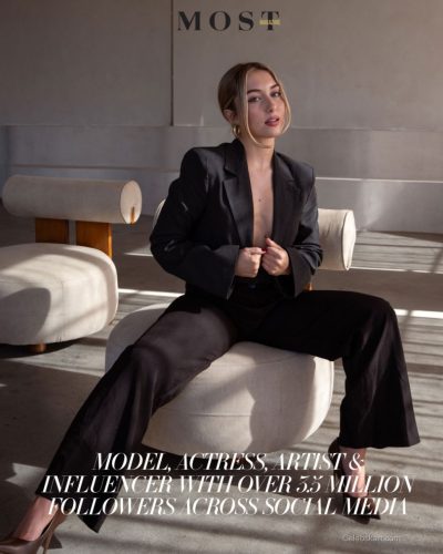 Heloise Huthart chic black gown raising glass in toast