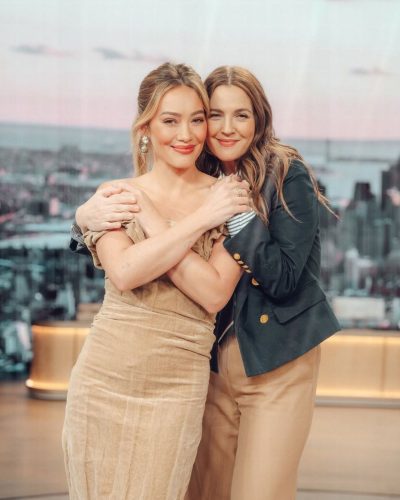 Hilary Duff wearing fitted beige dress with gathered fabric details