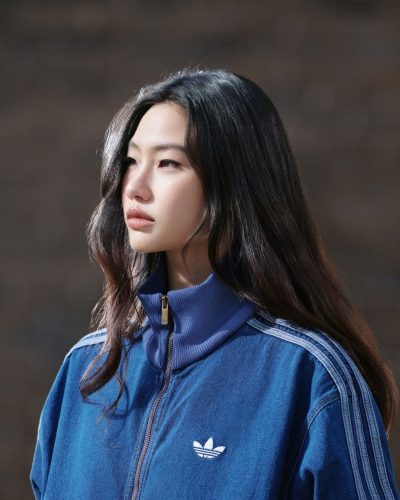 Hoyeon Jung in blue tracksuit jacket and playful skirt
