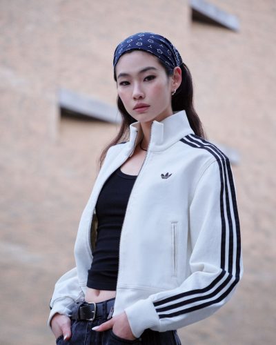Hoyeon Jung in blue tracksuit jacket with denim bottoms