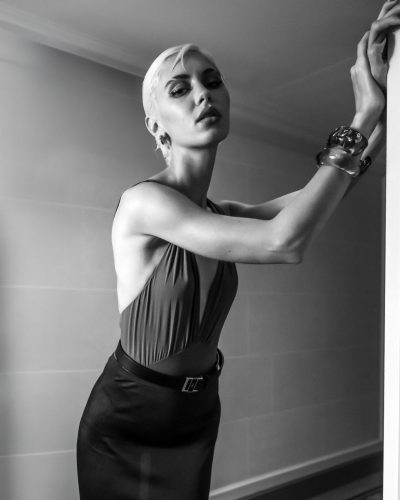 Iris Law in black dress accentuating her figure