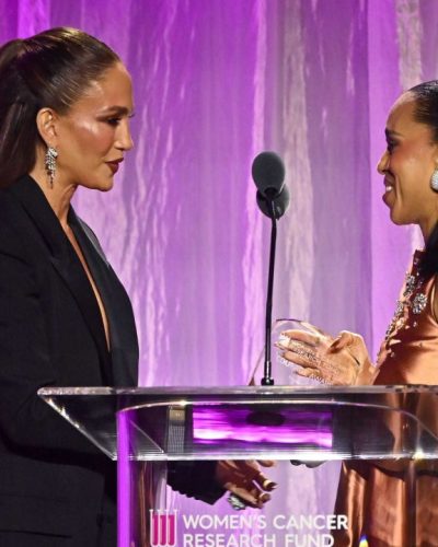 Jennifer Lopez wearing a black gown complemented by bold earrings