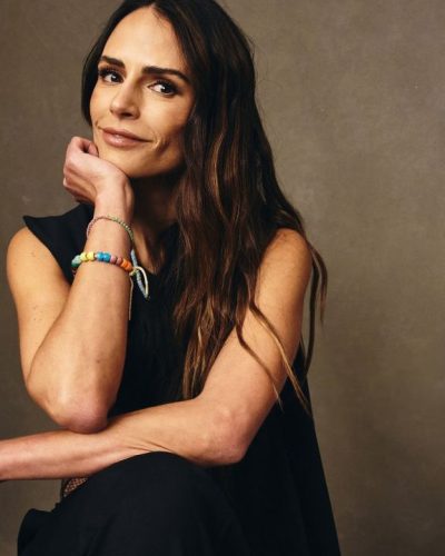 Jordana Brewster black gown complemented by colorful beaded bracelets