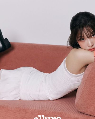 Joy wearing a black crop top and delicate lace skirt.