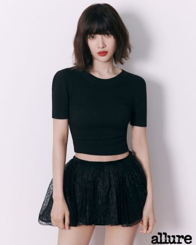 Joy in black crop top and stylish lace skirt.