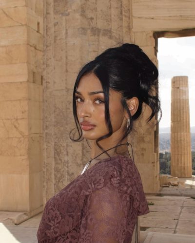 Kaaviya Sambasivam in black figure-hugging top and wide-leg trousers