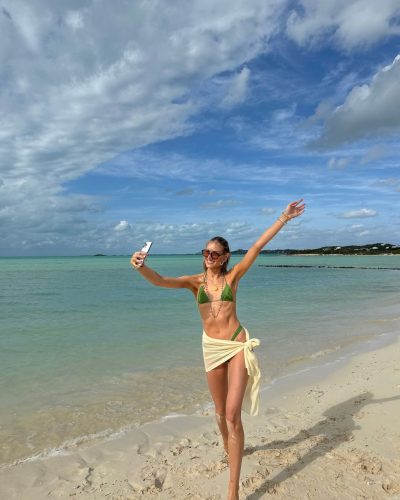 Kari Riley in a minimalist high-cut bikini in earthy tones.