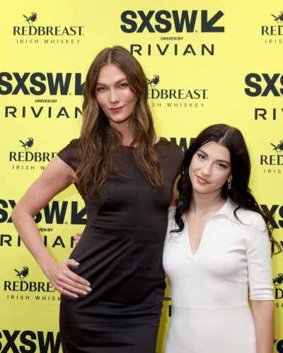 Karlie Kloss deep black dress with soft waves hairstyle