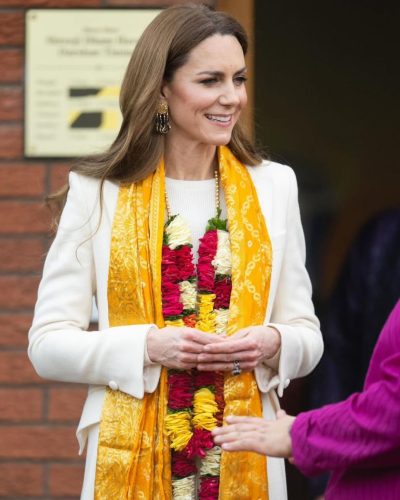 Kate Middleton structured cream coat paired with soft floral accents