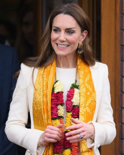 Kate Middleton vibrant floral garland complementing her cream coat