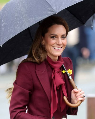 Kate Middleton fashionable burgundy top matching her wool coat