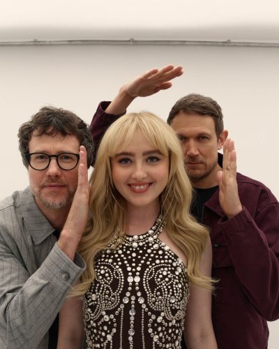 Kathryn Newton fitted brown dress accentuating her figure