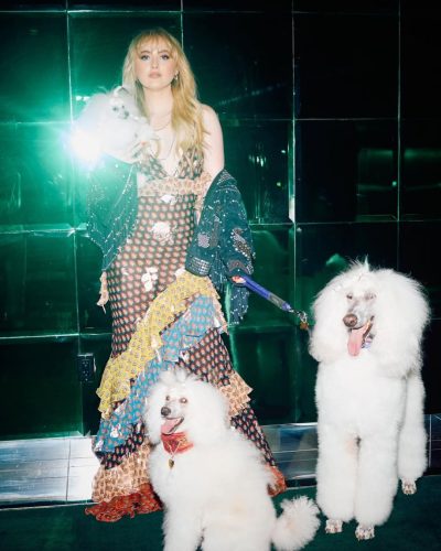 Kathryn Newton navy jacket draped over colorful dress