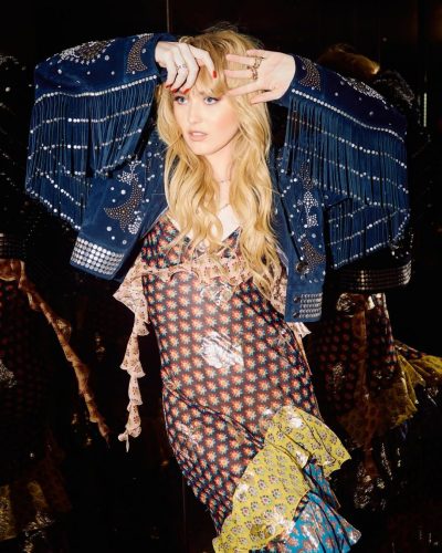 Kathryn Newton wearing navy jacket with metallic embellishments