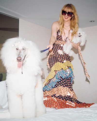 Kathryn Newton wearing delicate pearl necklace with playful dress