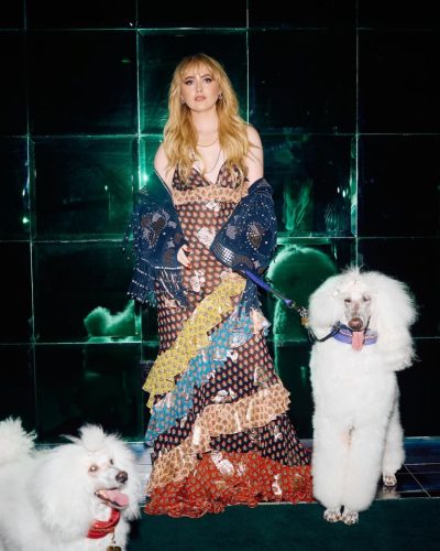 Kathryn Newton wearing delicate pearl necklace with playful dress