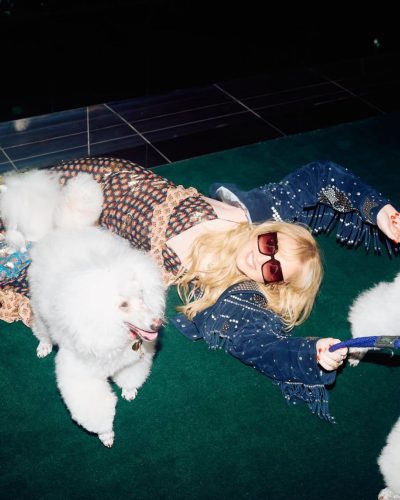 Kathryn Newton in layered textures with colorful floral dress