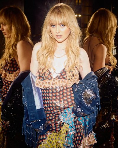 Kathryn Newton in playful ruffled dress with layered patterns