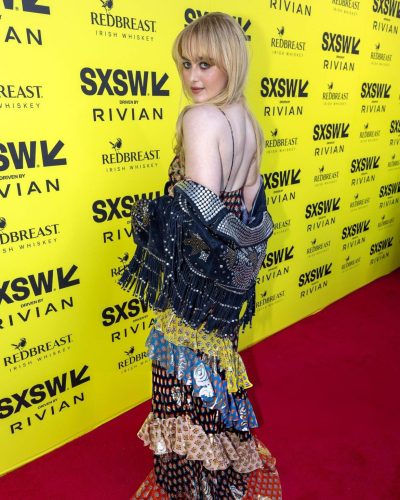 Kathryn Newton stylish floral dress with soft wave hairstyle.