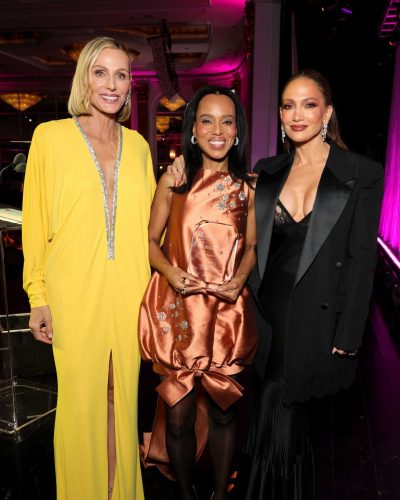 Kerry Washington in a bright orange gown and stylish black heels