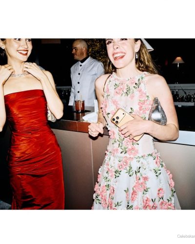 Kiernan Shipka vibrant floral dress with metallic clutch