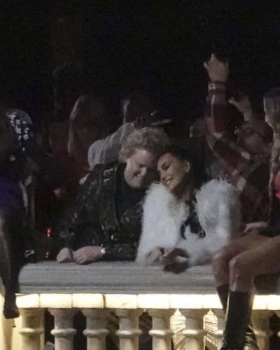 Kim Kardashian in white faux fur coat with black dress underneath