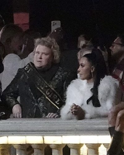 Kim Kardashian wearing black dress with white faux fur coat