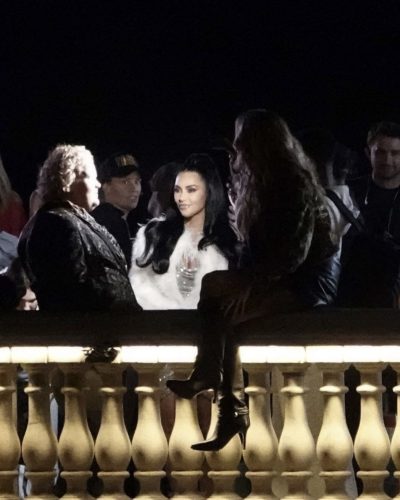 Kim Kardashian in white faux fur coat over black dress