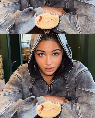 Komal Ilsanker wearing a sleek black jumpsuit with dramatic accessories